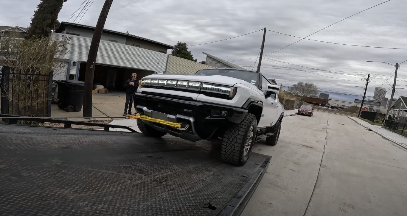 Large GMC Hummer EV being loaded onto a flatbed tow truck in Copiague, NY